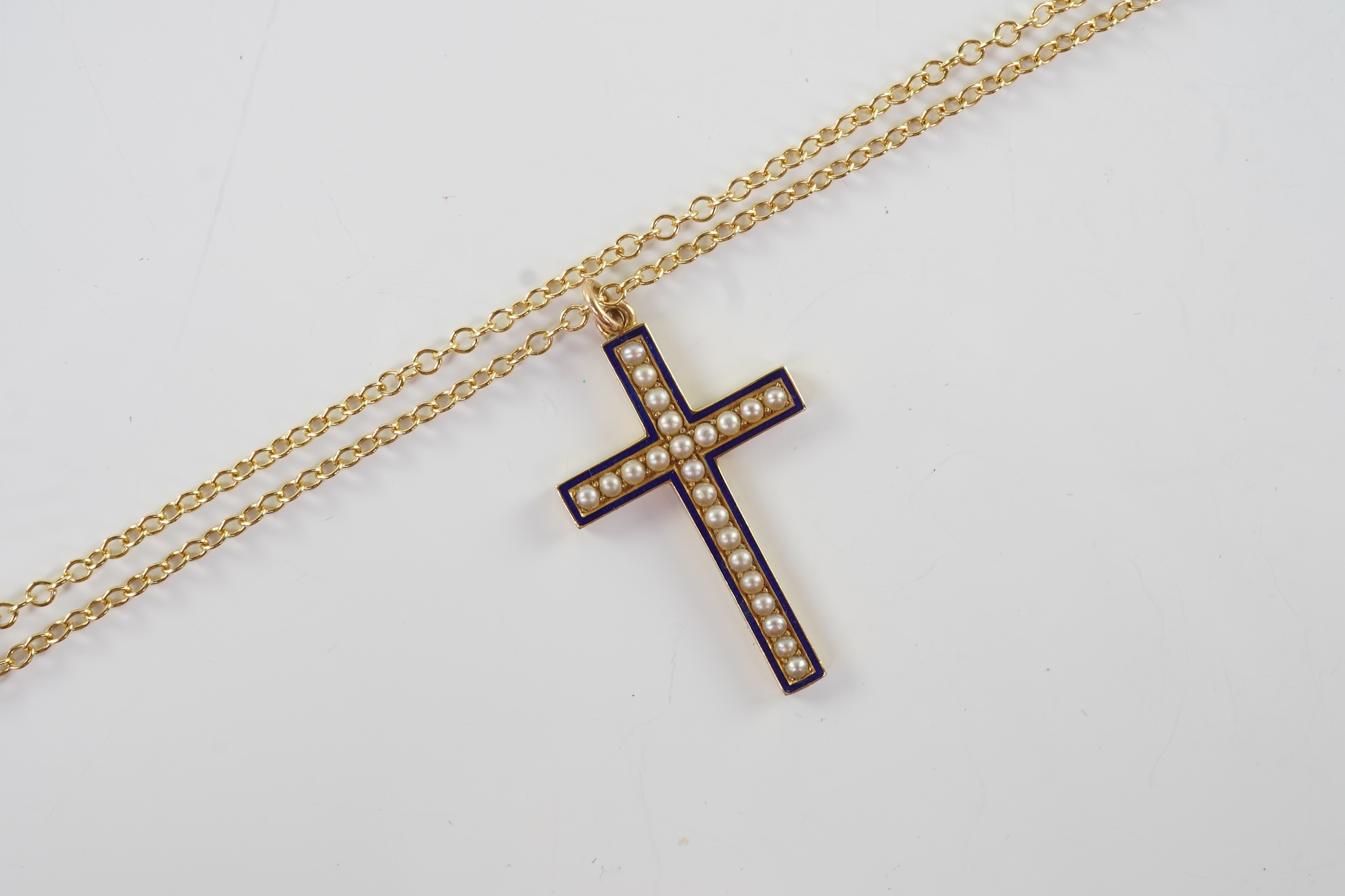 An Edwardian pearl and enamel cross and chain, early 20th century